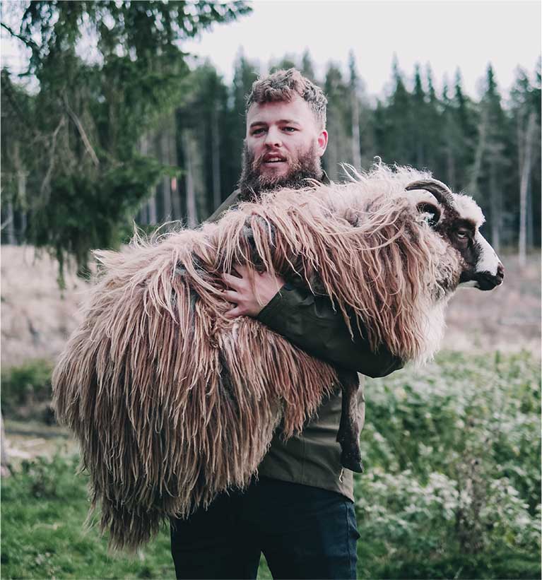 man carrying sheep